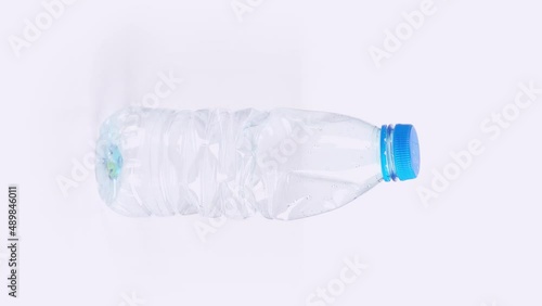 Vertical Plastic bottle crushing time lapse on white background Plastic pollution concept endless loop