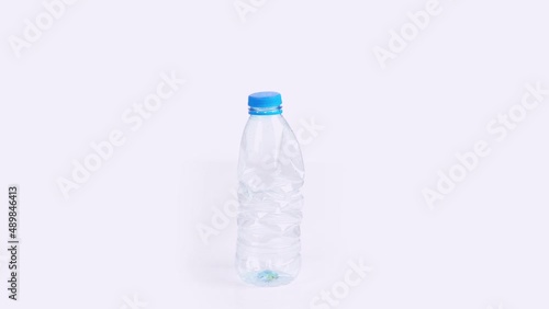 Plastic bottle crushing time lapse on white background Plastic pollution concept endless loop