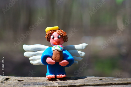 Fototapeta Naklejka Na Ścianę i Meble -  Figure of an angel with an Easter cake.