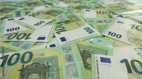 spreaded 100 euro banknotes background with bokeh 