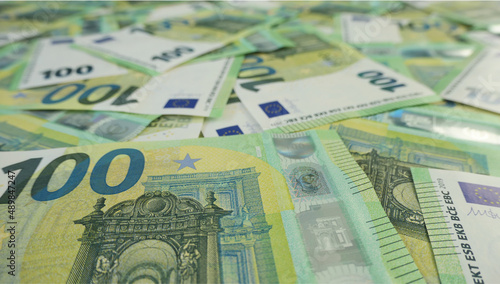 spreaded100 euro banknotes background with bokeh 
