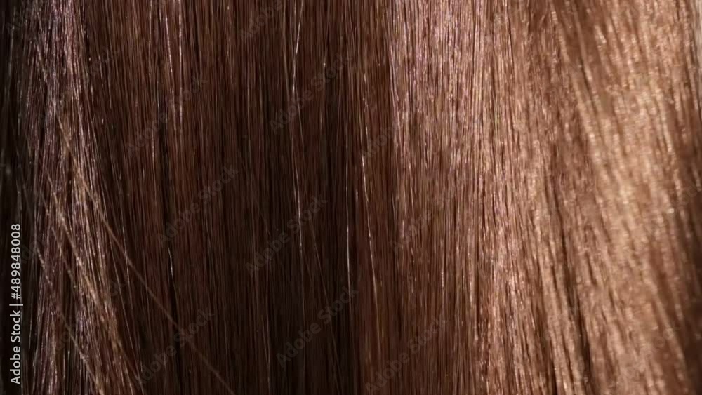 Beautiful healthy brown Hair. A closeup view of a bunch of shiny straight brown hair in a wavy style. slow motion smooth flowing hair fluttering Beautiful healthy brown Hair. A closeup view of a bunch of shiny straight brown hair in a wavy style. slow motion smooth flowing hair fluttering