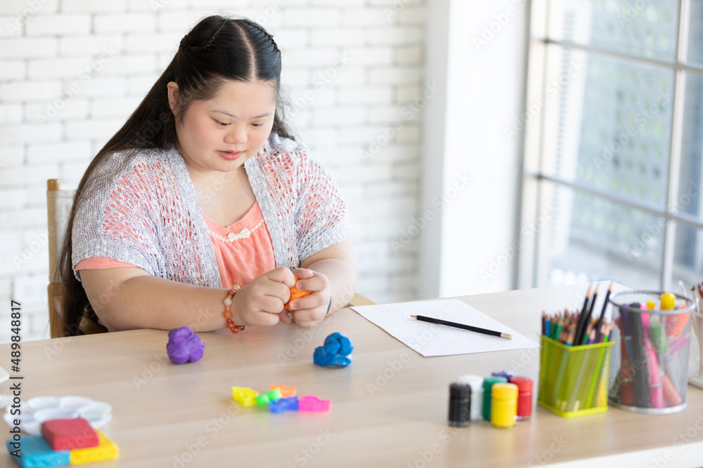 down syndrome girl sculpt plasticine figures on a table down syndrome girl sculpt plasticine figures on a table