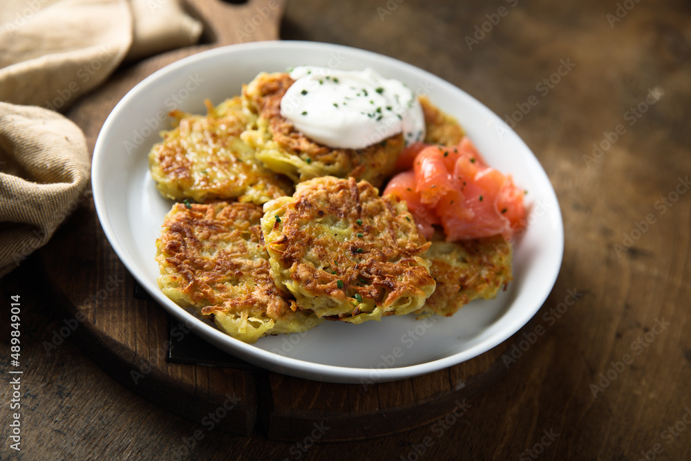 Homemade potato pancakes or lakes with salmon Homemade potato pancakes or lakes with salmon