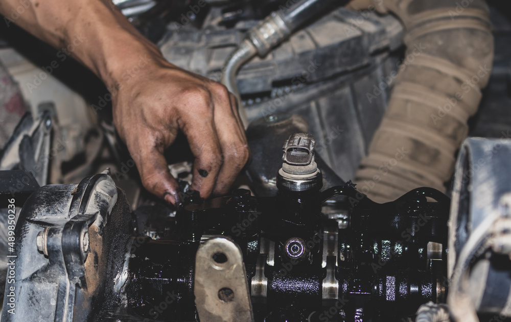 The mechanic is checking the engine. The mechanic is checking the engine.
