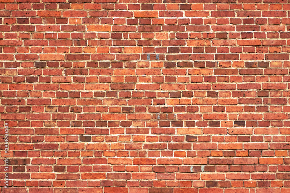 Fragment of an old red brick wall. Grunge textured background Fragment of an old red brick wall. Grunge textured background