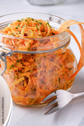 Russian carrot salad with parsley in a preserving jar photo