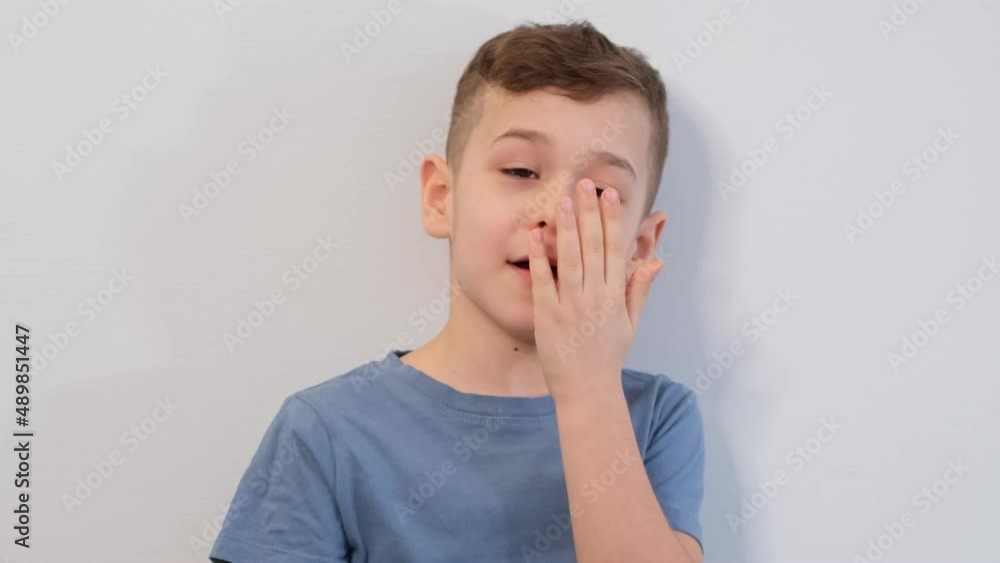Bad breath. Halitosis concept. Child checking his breath with his hand. Asian child preschool for medical and white background Bad breath. Halitosis concept. Child checking his breath with his hand. Asian child preschool for medical and white background