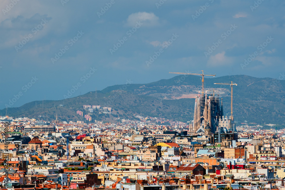 Barcelona, Spain - April 16, 2019: Aerial view of Barcelona city with famous Sagrada Familia basilica under construction