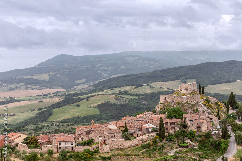 View of the medieval town Castiglione d'Orcia with his ruined castle on the hill. Tuscany, Italy
