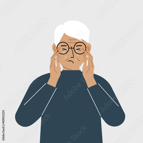 Upset grandfather cries and holds his head with his hands. The concept of resentment, pain and depression.