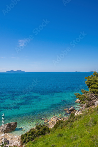 Sea wave and pebble. Summer vacation concept. Sea wave with foam incident on the coastal shingle. Travel concept