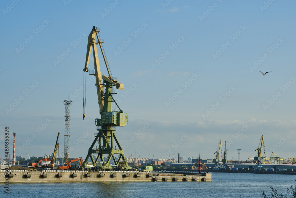 Cargo port cranes in St. Petersburg. Logistic concept. Cargo harbour for unloading and shipment goods from ships