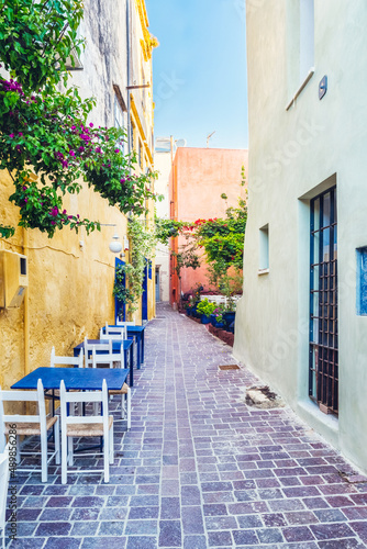 Street cafe in scenic picturesque streets of Chania venetian town with colorful old houses. Chania greek village in the morning. Chania, Crete island, Greece © Dmitry Rukhlenko
