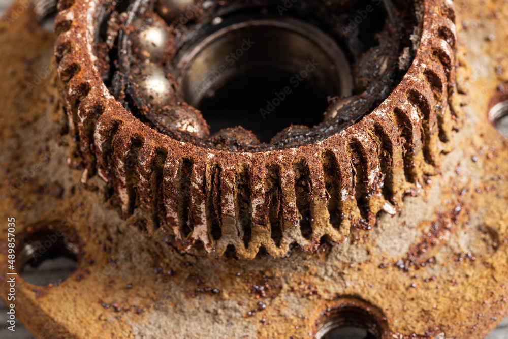 Old rusty wheel hub with a broken bearing. Bearing jamming. Automotive Part, close-up. Old rusty wheel hub with a broken bearing. Bearing jamming. Automotive Part, close-up.