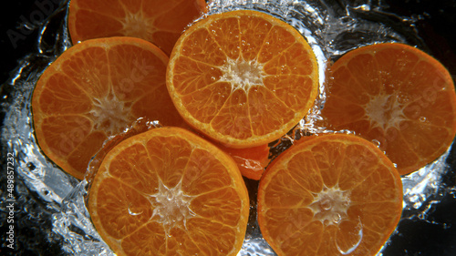 Fresh tangerines falling in...