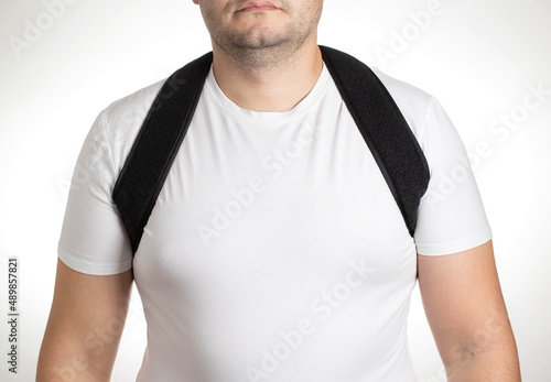 A male is wearing an orthopedic posture corrector. Treatment for stoop and back problems, close-up photo