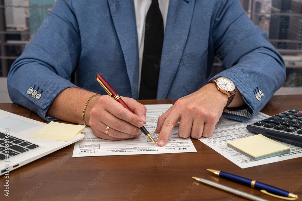 wise male businessman working with important documents at office desk. wise male businessman working with important documents at office desk.