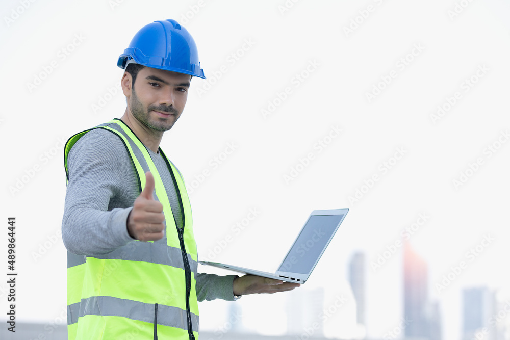 Smart engineer maintenance in solar power plant checking installing photovoltaic solar modules with laptop doing happy thumbs up gesture with hand. Concept of sustainable resources, saving energy. Smart engineer maintenance in solar power plant checking installing photovoltaic solar modules with laptop doing happy thumbs up gesture with hand. Concept of sustainable resources, saving energy.