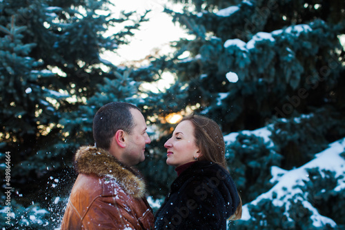 The couple in love in a winter park are looking at each other