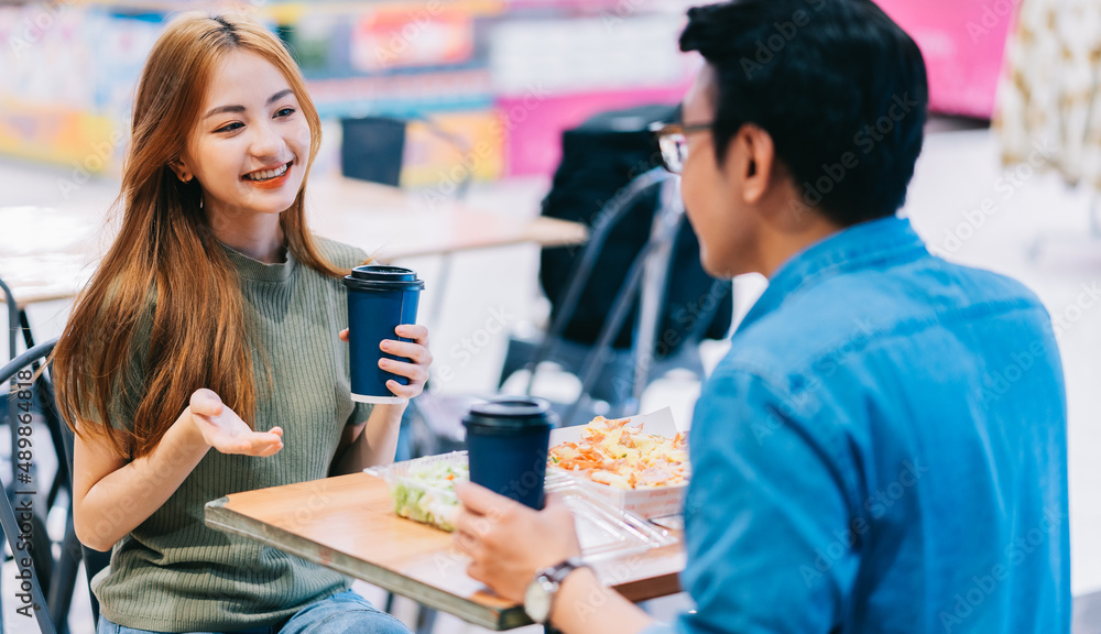 Young Asian couple having lunch together in cafe