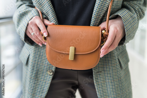 exquisite and stylish accessory in the form of a leather handbag is ideal for a fragile woman