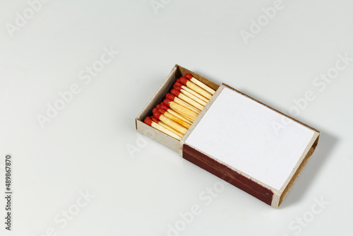 Close-up Matchbox with red matches on white background, selective focus. place for text. international match day
