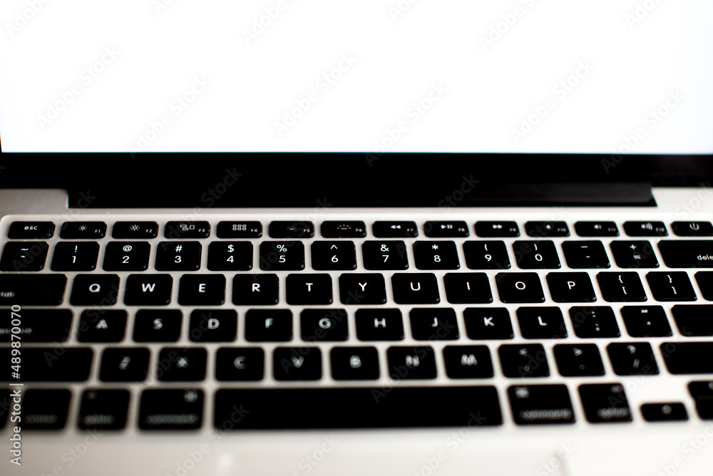Top view of open school notebook with blank pages, mock up laptop, glass od water and pencil on wood table background. Flat lay, creative workspace office. Business-education concept with copy space. Top view of open school notebook with blank pages, mock up laptop, glass od water and pencil on wood table background. Flat lay, creative workspace office. Business-education concept with copy space.
