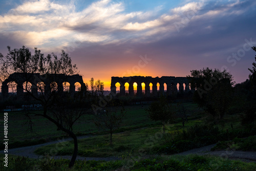 ancient Roman aqueduct of the 2nd century BC In Rome at sunset photo