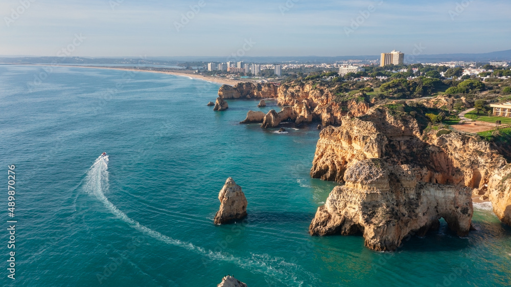 Aerial view of beautiful Portuguese beaches with rocky sandy shores and pure sand for tourists recreation in the Algarve in the south.