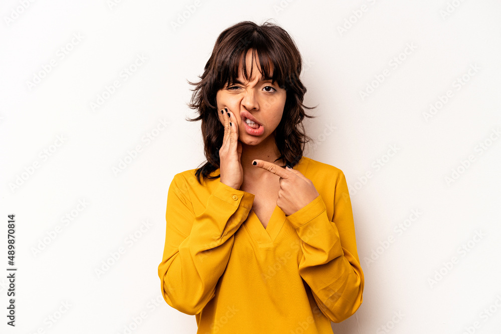 Young hispanic woman isolated on white background having a strong teeth pain, molar ache. Young hispanic woman isolated on white background having a strong teeth pain, molar ache.