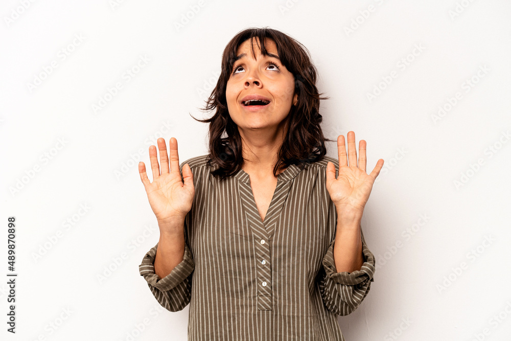Young hispanic woman isolated on white background screaming to the sky, looking up, frustrated. Young hispanic woman isolated on white background screaming to the sky, looking up, frustrated.