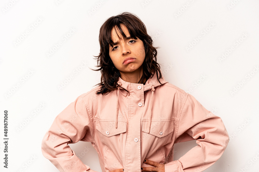 Young hispanic woman isolated on white background sad, serious face, feeling miserable and displeased.