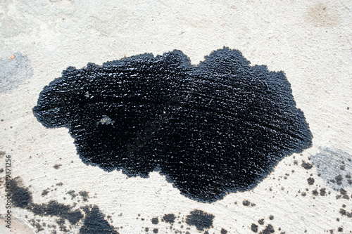 Stain of engine oil dripping onto the floor.