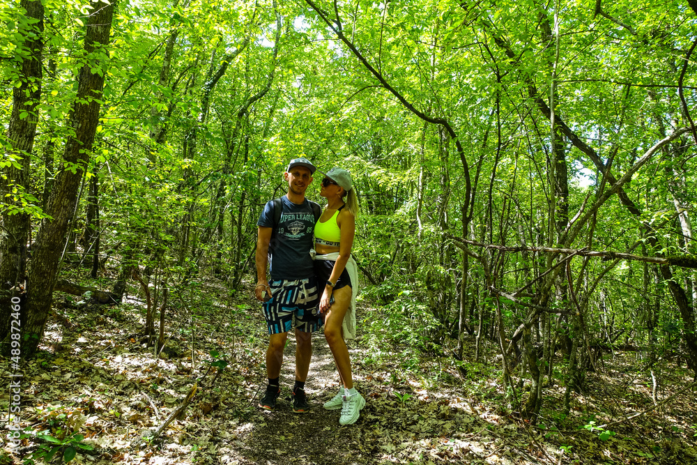 A man with a girl in the forest near the cave town of Tepe-Kermen Crimea Russia 2021 A man with a girl in the forest near the cave town of Tepe-Kermen Crimea Russia 2021