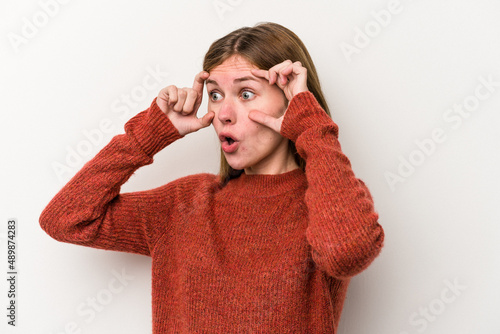 Young russian woman isolated on white background keeping eyes opened to find a success opportunity.