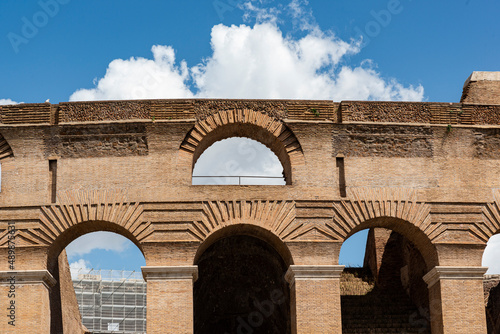 detail of the colosseum on a sunny day with clouds