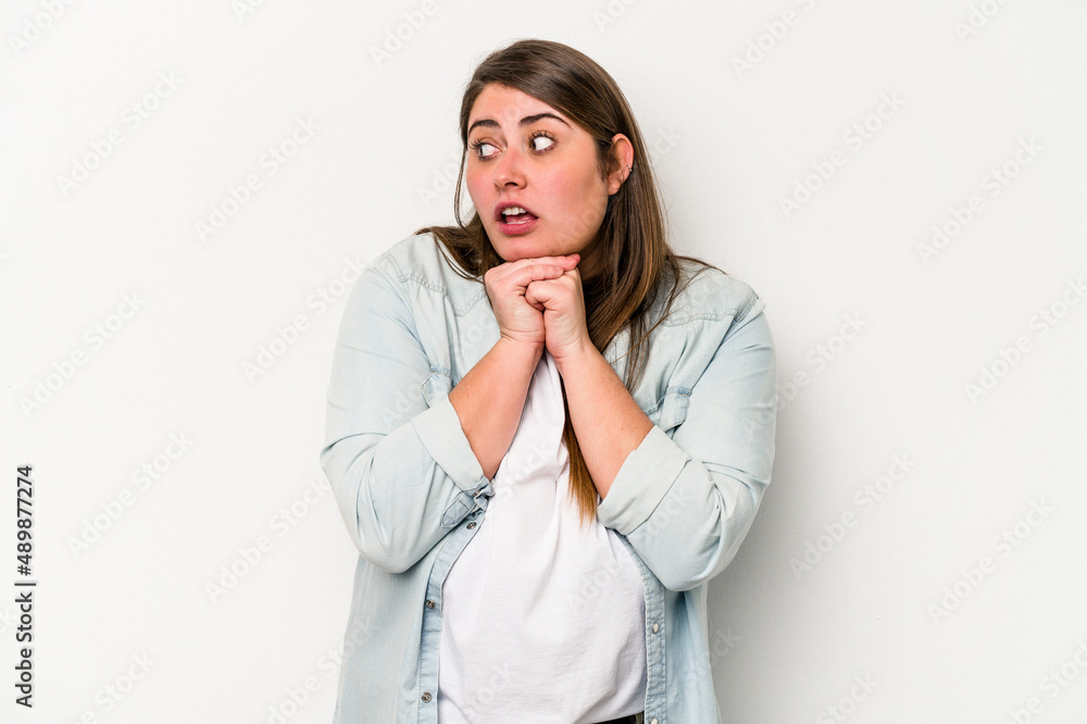 Young caucasian overweight woman isolated on white background praying for luck, amazed and opening mouth looking to front. Young caucasian overweight woman isolated on white background praying for luck, amazed and opening mouth looking to front.