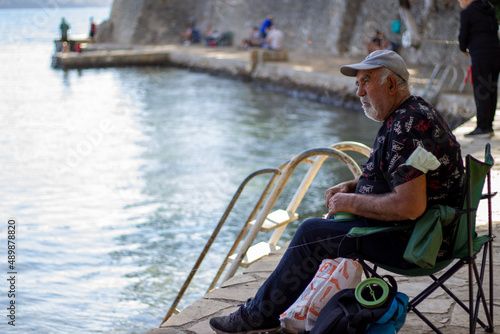 old man fishing by the sea