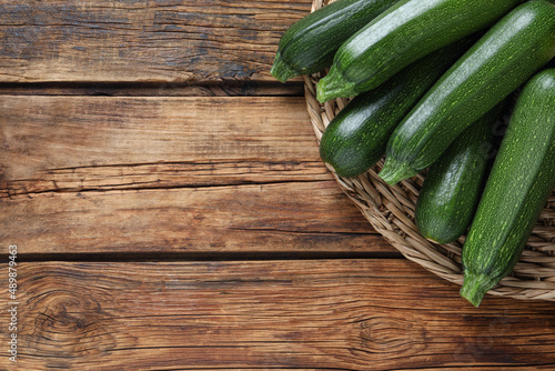 Raw ripe zucchinis on wooden table, top view. Space for text