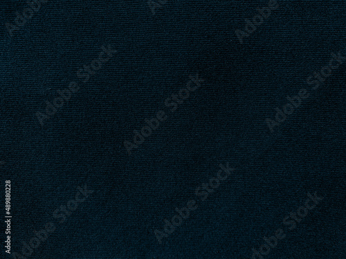 Dark blue velvet fabric texture used as background. Empty dark blue fabric background of soft and smooth textile material. There is space for text..