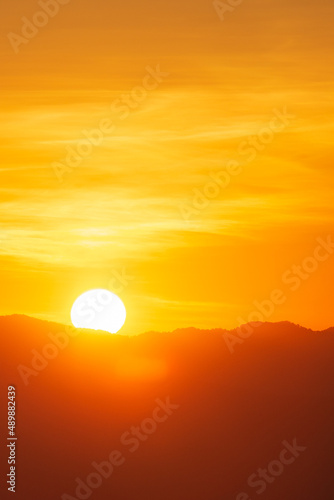 Closeup to sun over the mountain hill at sunrise time or morning time.