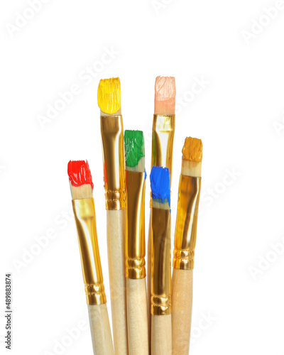 Brushes with bright paints on white background