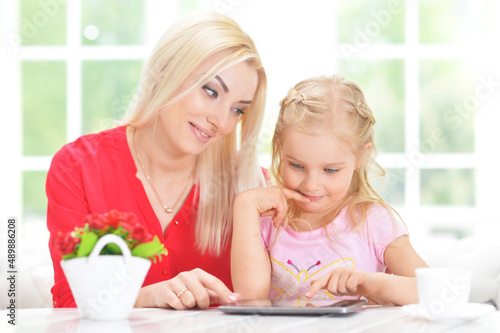 mother and daughter using tablet computer