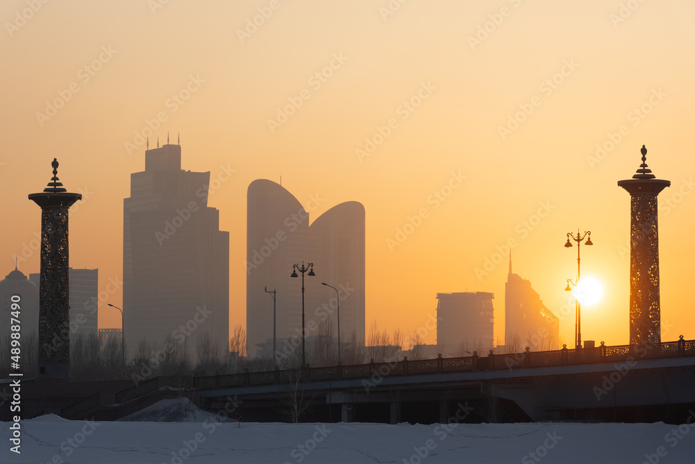 Sunset over Maral bridge and frozen River Ishim. Nur-sultan, Kazakhstan.