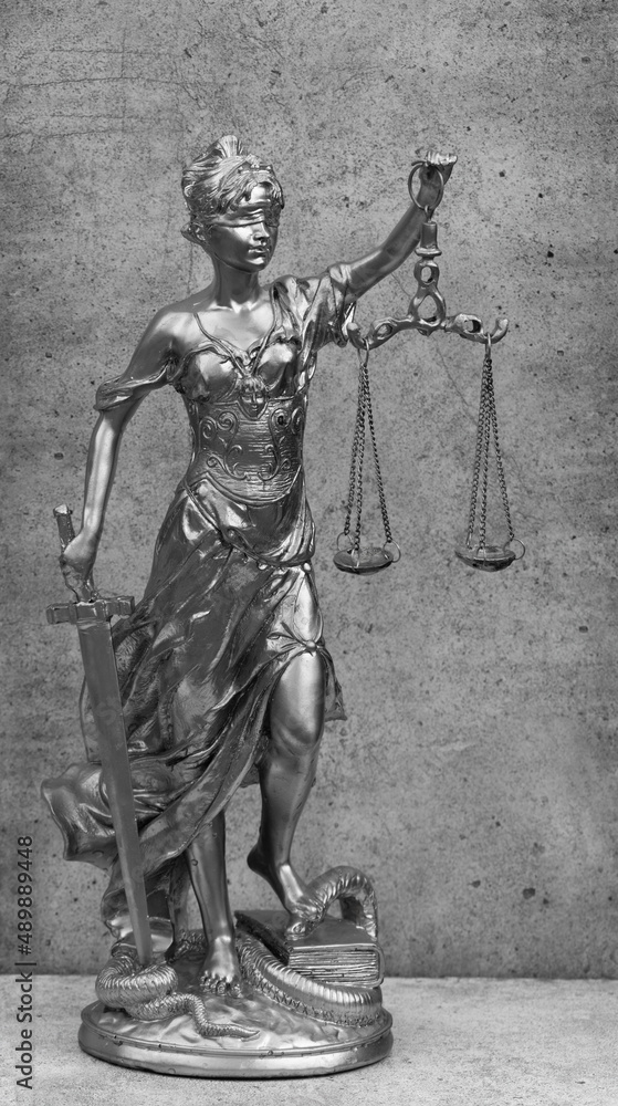Obraz premium silver figurine of Themis on a gray background