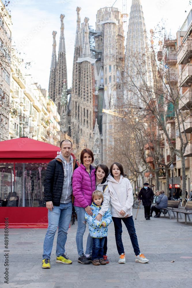 Cute little children tourists admiring Barcelona city, family travel with kids in Spain. Family with three children standing in front of Familia Sagrada