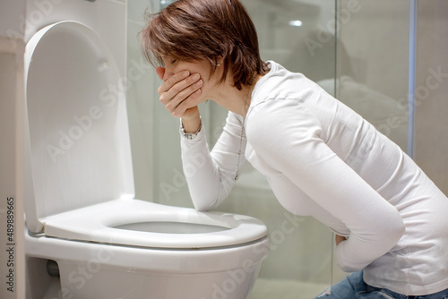 Woman, girl, experiencing sickness, vomiting, pregnancy, poisoning and morning discomfort photo