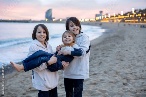 Canvas Print Cute little children tourists admiring Barcelona city, family travel with kids