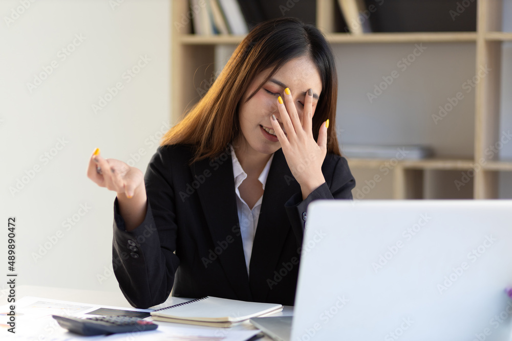 Businesswoman in the office suffering from stress headache and feeling tired and unwell. Businesswoman in the office suffering from stress headache and feeling tired and unwell.